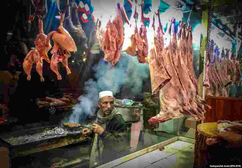 A man sells traditional grilled food at a shop in Kabul, Afghanistan. (epa-EFE/Hedayatullah Amid)