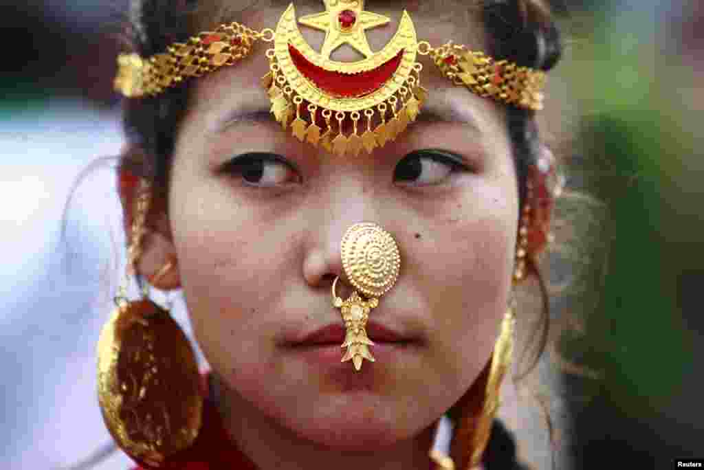 A woman wearing traditional ornaments participates in a parade in Kathmandu marking the 60th anniversary of the first ascent of Everest.