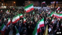 Iranians gather on Enqelab Square in Tehran on April 8 react after a temporary cease-fire between Washington and Tehran was announced.