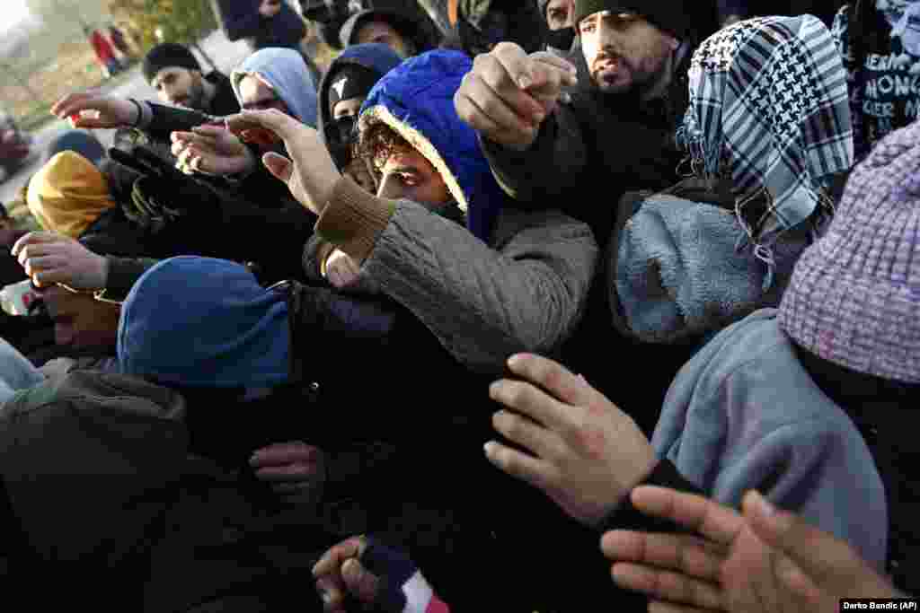 Migrants hoping to reach Greece receive food near the Pazarkule border crossing near Edirne, Turkey.