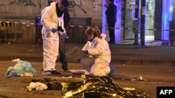 Italian police and forensics experts gather around the body of suspected Berlin truck attacker Anis Amri after he was shot dead in Milan on December 23.