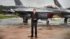 Polish Prime Minister Donald Tusk stands in front of F-16 fighter jets during a news conference on the threat posed by Russian drones on September 11.