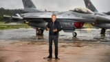 Polish Prime Minister Donald Tusk stands in front of F-16 fighter jets during a news conference on the threat posed by Russian drones on September 11.