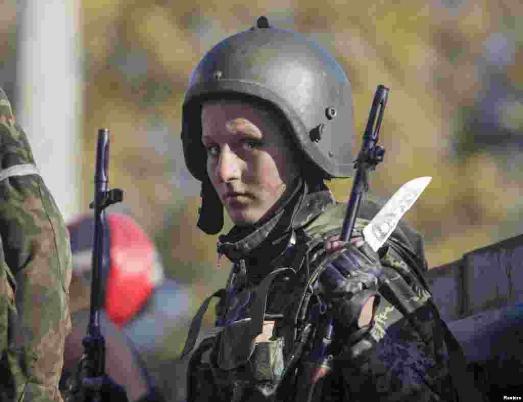 Irina, a female pro-Russian rebel, gets ready to take up a position near the Donetsk airport during fighting with Ukrainian government forces. Before fighting broke out in eastern Ukraine, Irina was a croupier in a casino. Using the nom de guerre &quot;Gaika,&quot;&nbsp;a cartoon character that translates as Gadget, she joined an artillery unit in a pro-Russian separatist group fighting government forces. (Reuters/Shamil Zhumatov) 