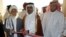 FILE: Former Qatari Assistant Minister for Foreign Affairs Ali bin Fahd al-Hajri (C) cuts the ribbon alongside a member of the Taliban's office Jan Mohammad Madani (L) at the opening ceremony of the new Taliban political office in Doha in 2013.