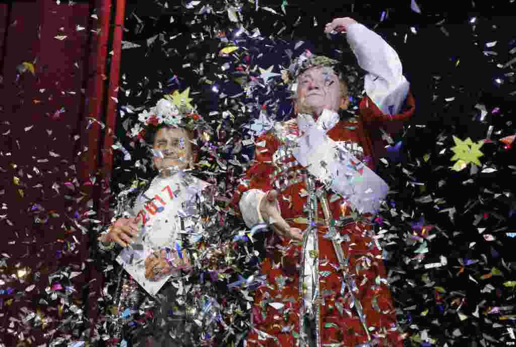 Georgian pensioners wave after winning a talent show in Tbilisi. The contest takes place every year before Orthodox Christmas and gives elderly actors and singers a chance to show off their talents. (epa/Zurab Kurtsikidze)