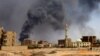 Smoke rises above the Sudanese capital, Khartoum, after bombardments on May 1. Some Afghans are unwilling to leave Sudan despite the fighting that has broken out in the past month. 