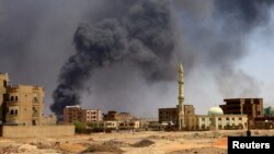 Smoke rises above the Sudanese capital, Khartoum, after bombardments on May 1. Some Afghans are unwilling to leave Sudan despite the fighting that has broken out in the past month. 
