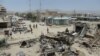 Afghan security personnel keep watch at the scene of the July 15 suicide attack in Orgun district, Paktika province, July 16, 2014.