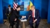  Ukrainian President Volodymyr Zelenskyy (left) shakes hands with US President Donald Trump during their meeting on the sidelines of the NATO summit in The Hague on June 25. 