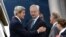 U.S. Secretary of State John Kerry (left) speaks with Swedish Foreign Minister Carl Bildt (center) as he arrives in Stockholm.