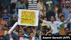 Pakistani spectators cheer at the start of the first Twenty20 international match between the World XI and Pakistan at the Gaddafi Cricket Stadium in Lahore on September 12.