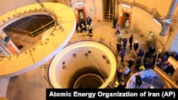 Officials and media tour the heavy water reactor's secondary circuit in Arak, Iran, in 2019. Observers say Iranian officials appear to have concluded that they need a revived nuclear deal to address the country's economic woes.
