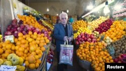 Iran -- A man leaves after shopping at a fruit store in Tehran, 06Jan2012