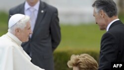 Maria Cavaco Silva (center), the wife of Portuguese President Anibal Cavaco Silva, kisses Pope Benedict's hand during a visit to the Jeronimos Monastery in Lisbon on May 11.