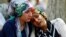 Women mourn as they wait in front of a hospital morgue in the Turkish city of Gaziantep after a suspected bomber targeted a wedding celebration in the city, killing at least 51.