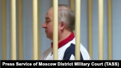 Sergei Skripal stands behind bars in a courtroom in Moscow in August 2006.