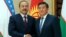 Kyrgyz Prime Minister Sooronbai Jeenbekov (right) welcomes Uzbek Prime Minister Abdulla Aripov to Bishkek on August 16.