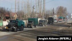 A group of trucks with relief supplies from Uzbekistan to the Sokh exclave arrive at a checkpoint.