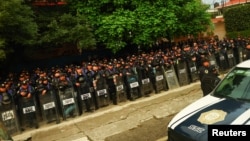 Polițiști în fața stadionului Azteca din Ciudad de Mexico înaintea primului meci găzduit de capitala mexicană, pe 11 iunie.