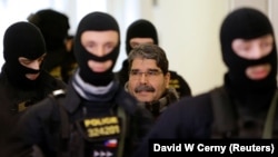 Salih Muslim is escorted to a Czech court in Prague on February 27.