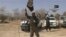 A video grab shows the leader of the Islamist extremist group Boko Haram, Abubakar Shekau, holding up a flag as he delivers a message.