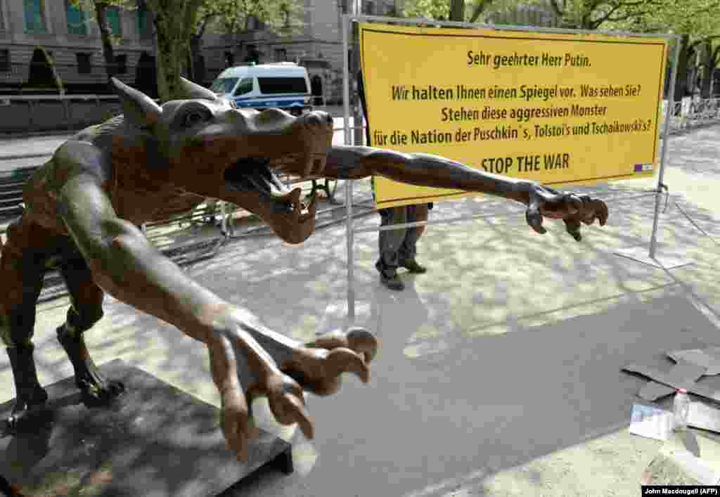 One of several sculptures of wolves installed close to the Russian Embassy in Berlin. The sign says "Dear Mr. Putin, we are holding up a mirror to you. What do you see? Do these aggressive monsters represent the nation of [Russian artists] Pushkin, Tolstoy, and Tchaikovsky?" The protest art was installed in April 2022.