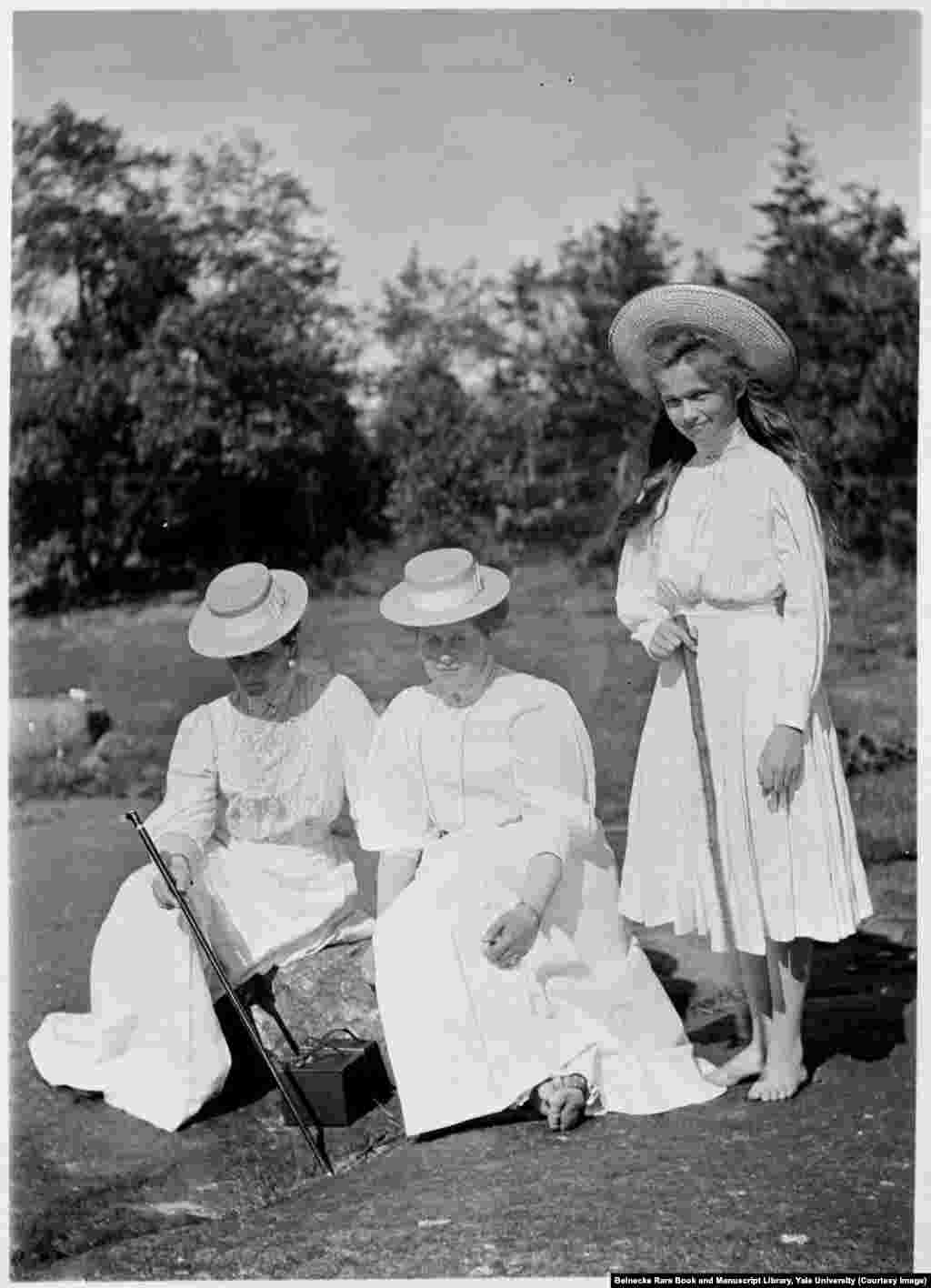 Empress Aleksandra (left) with Anna&nbsp;Vyrubova, and Olga, the eldest of the grand duchesses.&nbsp;Anna was arrested after the revolution but managed to escape to Finland with the albums, which contain more than 2,600 photographs of the private lives of the Romanovs. She died in Helsinki in 1964.