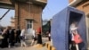 Staff members check temperatures of students as they arrive for an exam at a university in Peshawar, the capital of northwestern Khyber Pakhtunkhwa Province.