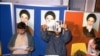 Iranian student spokesmen hold up photos of blindfolded American hostages, during a press conference in Tehran Monday November 5, 1979. The hostages are members of the staff of the United States Embassy in Tehran, which was stormed by students November 4