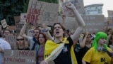 Protesters shout slogans and hold placards during a demonstration against a law that removes the independence of the NABU and SAPO anti-corruption agencies, in Kyiv on July 24, 2025, amid the Russian invasion of Ukraine