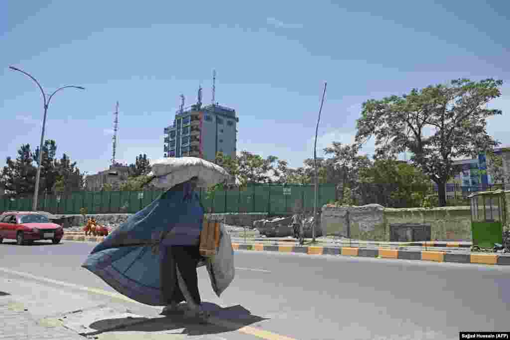 A woman in Kabul on August 7 &nbsp; Although some women continued to wear burqas after the fall of the Taliban in 2001, RFE/RL&#39;s Radio Azadi says use of the garments -- which commonly cost between 2,000-6,500 afghanis ($25-$80) -- had steadily declined in recent years.