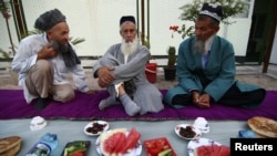 Muslim elders sit before a meal to celebrate a religious festival organised by the Islamic Renaissance Party in Dushanbe.