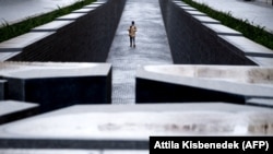 A young visitor walks around the Trianon Memorial, close to the parliament building in Budapest in January 2021.