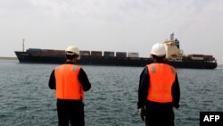 Iran - Workers watch a ship as it sails during an inauguration ceremony of new equipment and infrastructure at Shahid Beheshti Port in the coastal city of Chabahar, February 25, 2019.