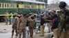 Pakistani police officers and paramilitary soldiers guard the site of a fatal attack in Quetta on February 14.