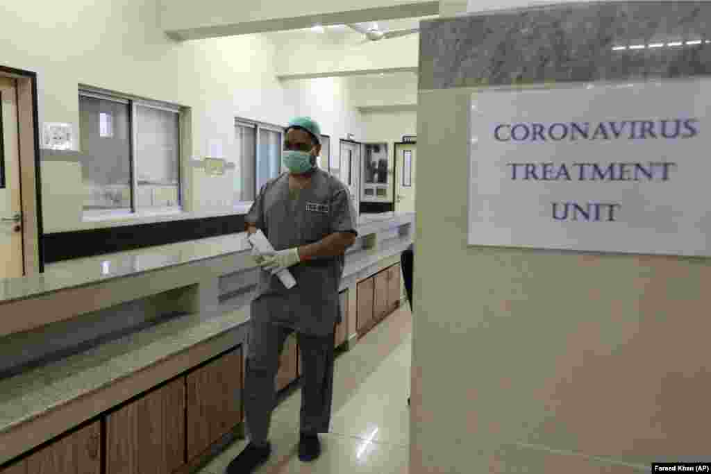 A Pakistani doctor enters an isolation ward set up as a preventative measure at the Jinnah Postgraduate Medical Center in Karachi, Pakistan.