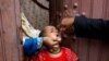A girl receives the polio vaccine in a low-income neighborhood of Karachi on July 20. Pakistan, along with Afghanistan, has the world's only remaining cases.