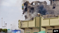 A rocket-propelled grenade rips into a building in the besieged Libyan city of Misurata.