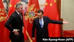 Chinese Prime Minister Li Keqiang (right) greets Montenegro' then-Prime Minister Milo Djukanovic during their meeting n Beijing in 2015. 