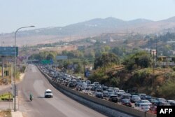 Vehicles wait in traffic in Damour, south of the capital, Beirut, as people flee southern Lebanon on September 24.