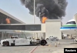 Smoke and flames rise from the international airport in Riyadh on October 8 after an attack claimed by Yemen's Iran-allied Houthis.
