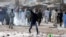A supporter of the Islamist Tehrik-e Labaik party hurls stones toward police during a protest against the arrest of their leader in Lahore, on April 13. 
