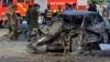 Pakistani security officials inspect the site of the deadly explosion in Lahore on July 24.