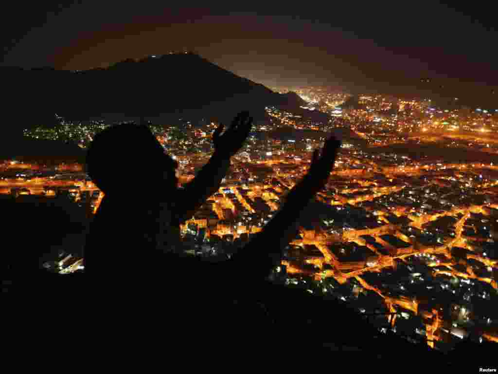 A Muslim pilgrim prays atop Mount Al-Nur during the annual hajj pilgrimage in Mecca on November 9. The haj is one of the world's biggest displays of mass religious devotion and a duty for Muslims who can perform it. Photo by Muhammad Salem for Reuters