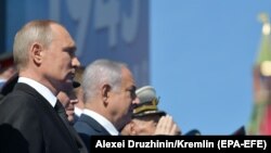 Russian President and the Supreme Commander-in-Chief of the Russian Armed Forces Vladimir Putin (L) and Israeli Prime Minister Benjamin Netanyahu (2-L) attend the Victory Day military parade in the Red Square in Moscow, 09 May 2018.