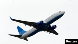 Russia -- A Boeing 737-800 NG, owned by Dobrolyot airline and heading to Simferopol, flies after taking off at Sheremetyevo International Airport outside Moscow, June 10, 2014