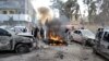 People gather at the site of a suicide bombing in Quetta on February 17.