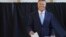 Romanian President Klaus Iohannis casts his vote in a May 26 referendum on changes to the country's judiciary and anti-corruption legislation. 