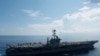 AT SEA -- An MH-60R Sea Hawk piloted by Cmdr. Paul D. Will (top), breakes formation during an aerial change of command ceremony above USS John C. Stennis (CVN 74) in the South China Sea, May 20, 2016